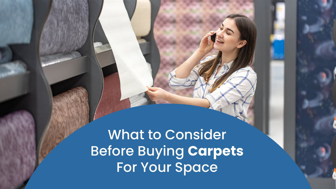 Smiling woman on the phone shopping for carpets, holding a carpet sample in a store with various rolled carpet options on display