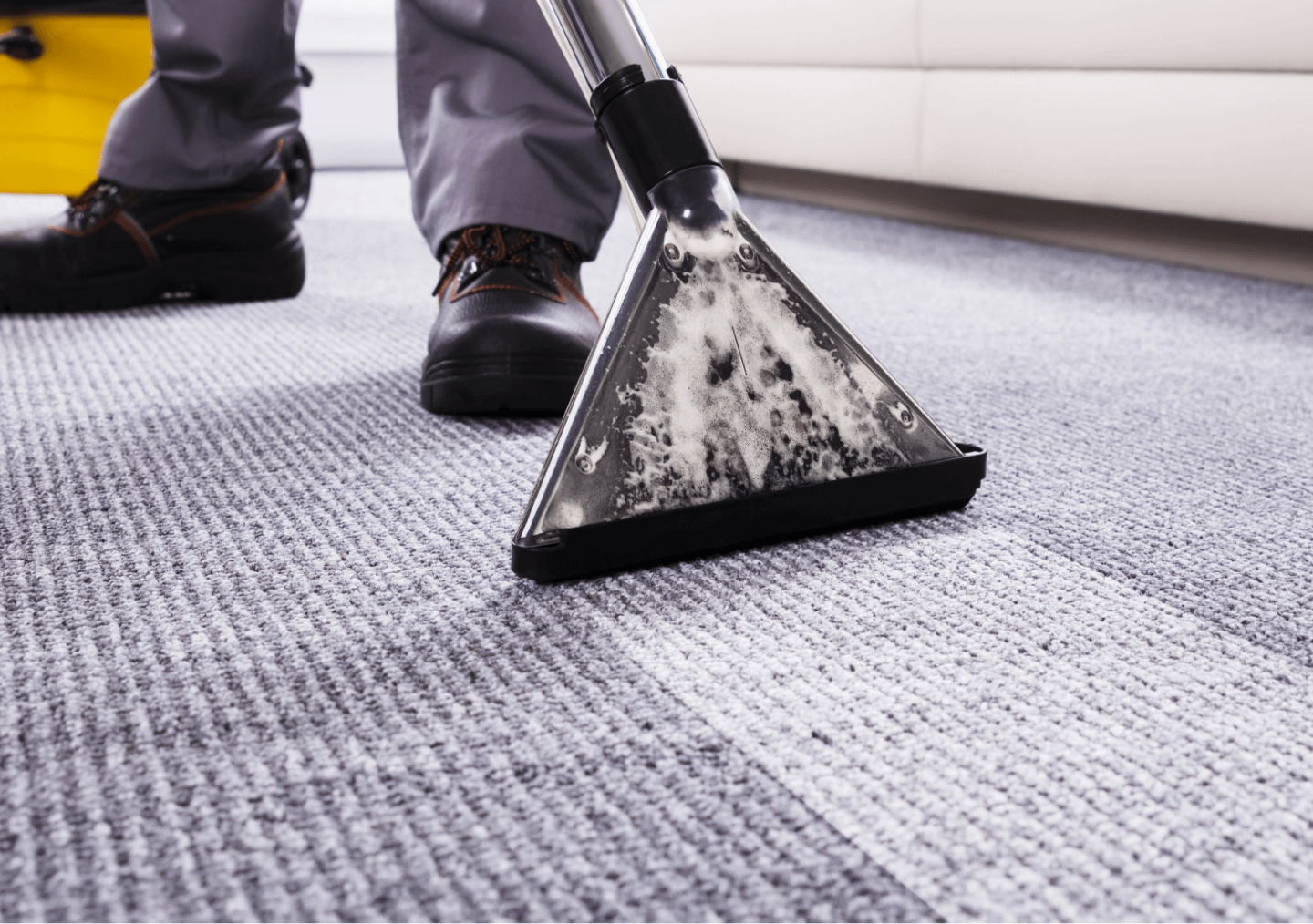 A close-up image of a vacuum cleaner on textured carpet with icons for contacting support and booking a service.